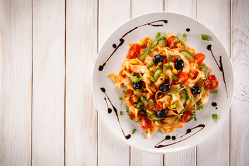 Pasta with meat, tomato sauce and vegetables 