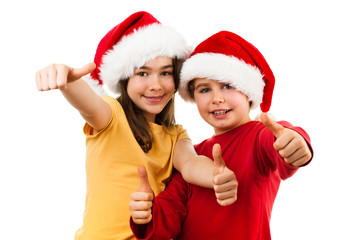 Christmas time - girl and boy with Santa Claus Hat showing OK sign 