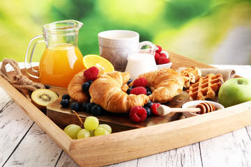 Breakfast served with coffee, orange juice, croissants and fruits. Balanced diet.