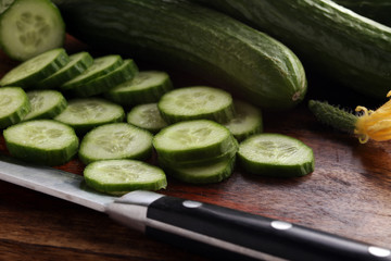 Fresh and sliced cucumbers. Sliced cucumbers on a cutting board. cucumbers for diet and healthy eating