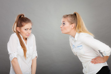 Angry fury girl screaming at her friend or younger sister