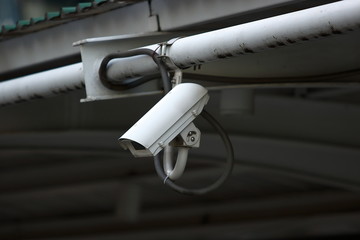 Naklejka na ściany i meble Security CCTV camera or surveillance in city.