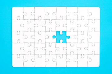 White jigsaw puzzle on blue background