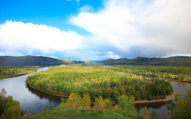 Fototapeta na wymiar beautiful autumn landscape with curving river and forest under blue sky