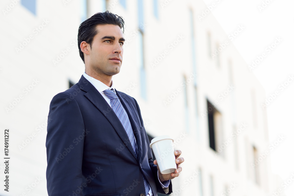 Wall mural businessman drinking coffee to go with a take away cup