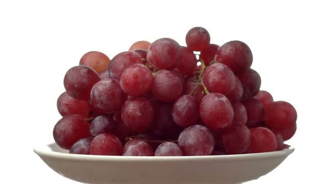 Ripe grapes in the plate on white background. Dolly shot
