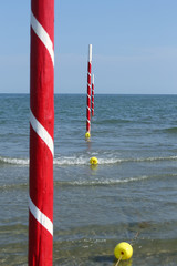 white and red poles on the sea