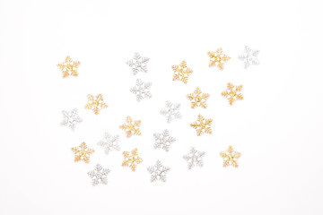 Christmas decorations,  silver snowflakes and gold snowflakes on white background.