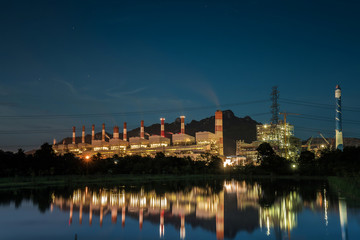 Coal power plant at water front with reflection