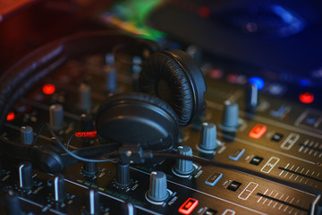 Fototapeta na wymiar DJ mixer in bright colors disco in a nightclub. 