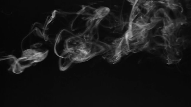 White smoke in the form of rings on a black background.