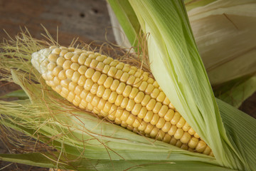 fresh corn on wooden table