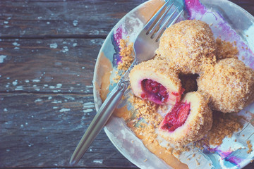 Top view of a colorful plate with plum dumplings