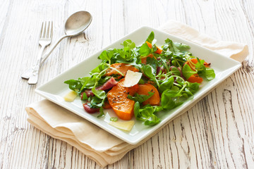 Salad with pumpkin, bacon , cheese and arugula