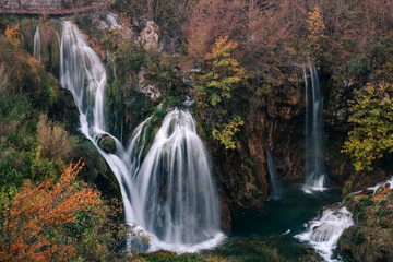 Croatia. Plitvice Lakes. A cascade of waterfalls surrounded by autumn forest.