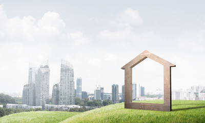 Conceptual image of concrete home sign on hill and natural landscape at background