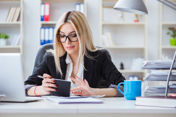 Businesswoman working on laptop at the desk in the office