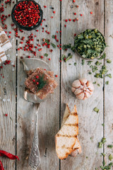 aspic with horseradish and bread slices on wooden background