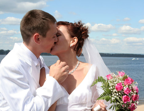 the bride and groom kiss