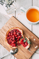 diet cherry pie, and sliced on a wooden Board with tea