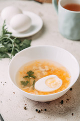 soup with egg on a wooden table