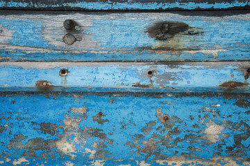 Old wooden boat wall background, Close up of wall with layers of chipping paint flakes