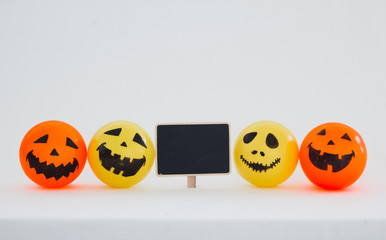 Self Made Hand Drawn Smiley Halloween face yellow and orange ball  and a black signboard