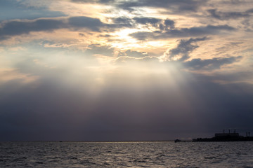 Backlit of sea and the sky with the light of the sun shines down impact.