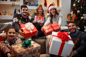 Young happy people with gifts for Christmas