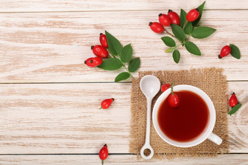 tea with rose hips and honey on a white wooden background with copy space for your text. Top view