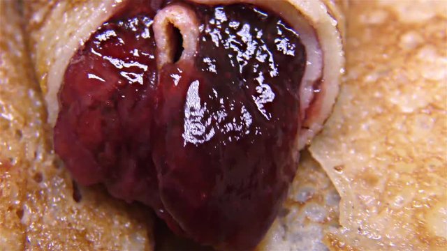 Tasty pancake rolls  with topping, homemade strawberry jam &ndash; detail, closeup