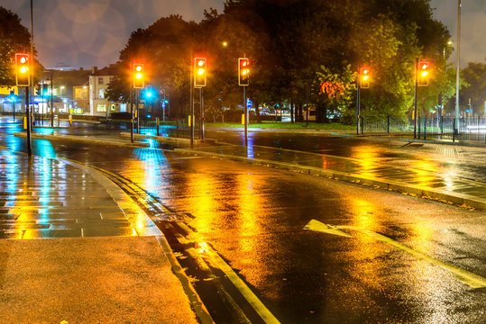 Night Rain View Yellow Traffic Lights At UK Roundabout