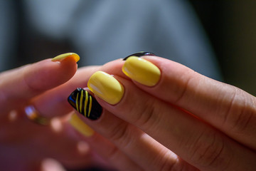 Closeup of female hands with yellow nails