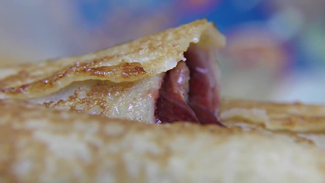 Tasty pancake rolls  with topping, homemade strawberry jam – detail, closeup