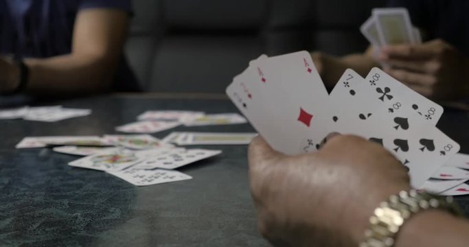 Playing cards in hand on table