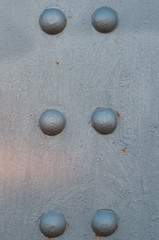 silver metal background with rivets and arches