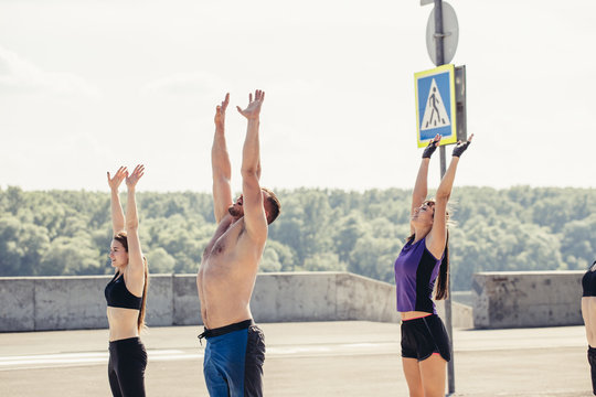 happy teenage friends exercising at boot camp