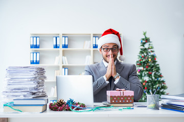 Young businessman celebrating christmas in the office