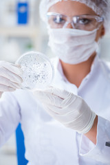 Female scientist researcher conducting an experiment in a labora