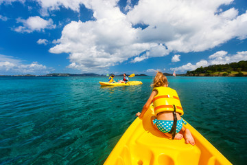 Family kayaking at tropical ocean