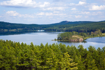 Fototapeta na wymiar summer landscape, pines, lake and mountains, silhouette of boat, clouds in the sky, Bashkiria, Ural, Russia, Lake Kalkan
