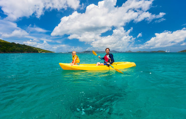 Family kayaking at tropical ocean