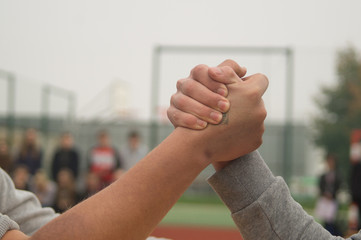 two aggressive teenagers fight fist at the table