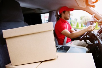 parcel delivery man drive a car smiling  transport postal delivery courier delivering package....