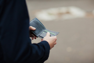 Hipster man hands holding wallet with credit cards and stack of money