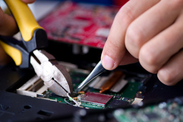 Fototapeta na wymiar Repairman working in technical support fixing computer laptop tr