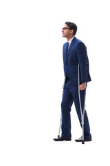 Businessman walking with crutches isolated on white background