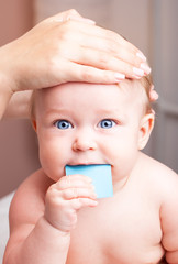 Little baby receiving chiropractic treatment of her head