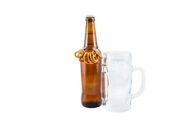 Bottle of beer with pretzels and goblet for beer isolated on white.