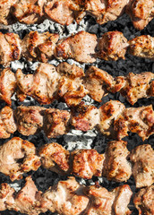 Shashlik prepares on the mangal. Food background. Top view.